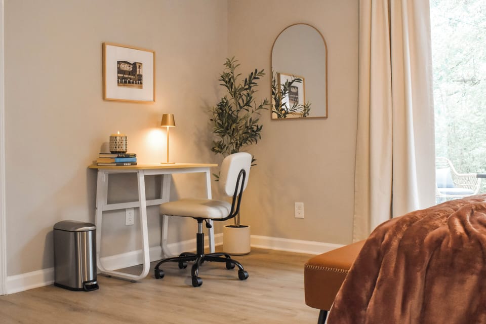 The master suite features a dedicated workspace designed for productivity. Perfect for laptops