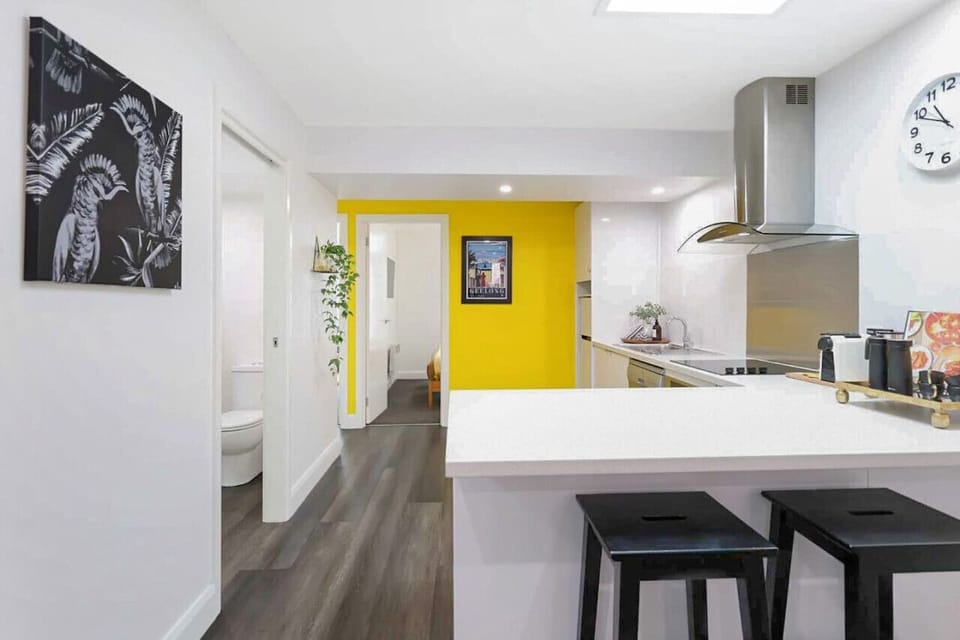 Sleek kitchen flowing into a bright hallway