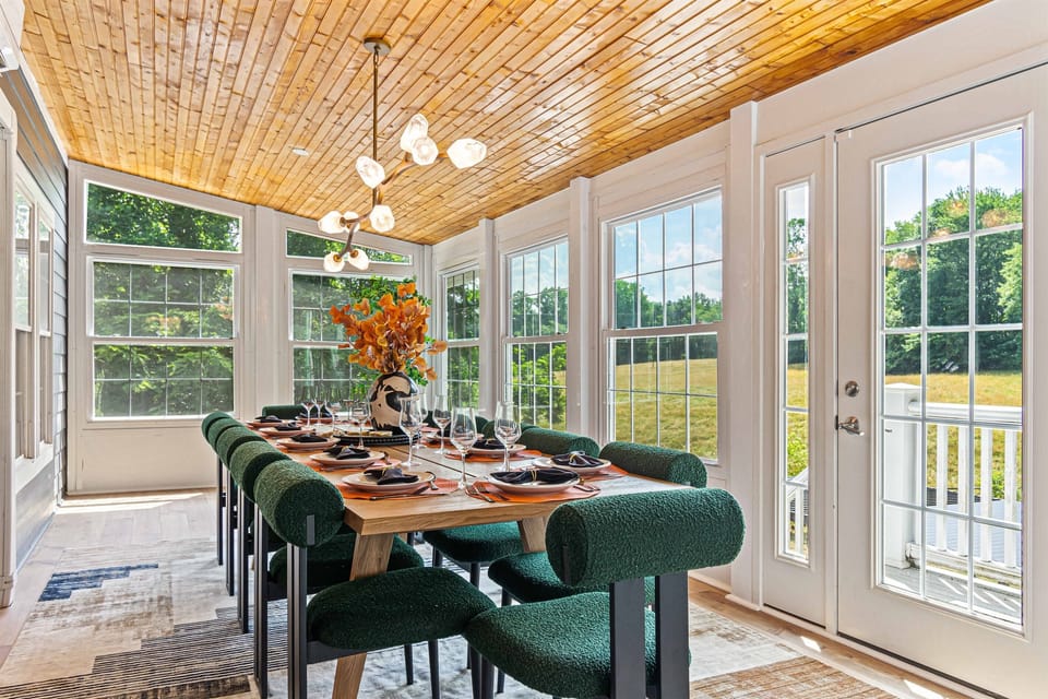 The spacious dining room comfortably seats 12. Views of the peaceful meadows, creating a serene backdrop for gatherings with family and friends.