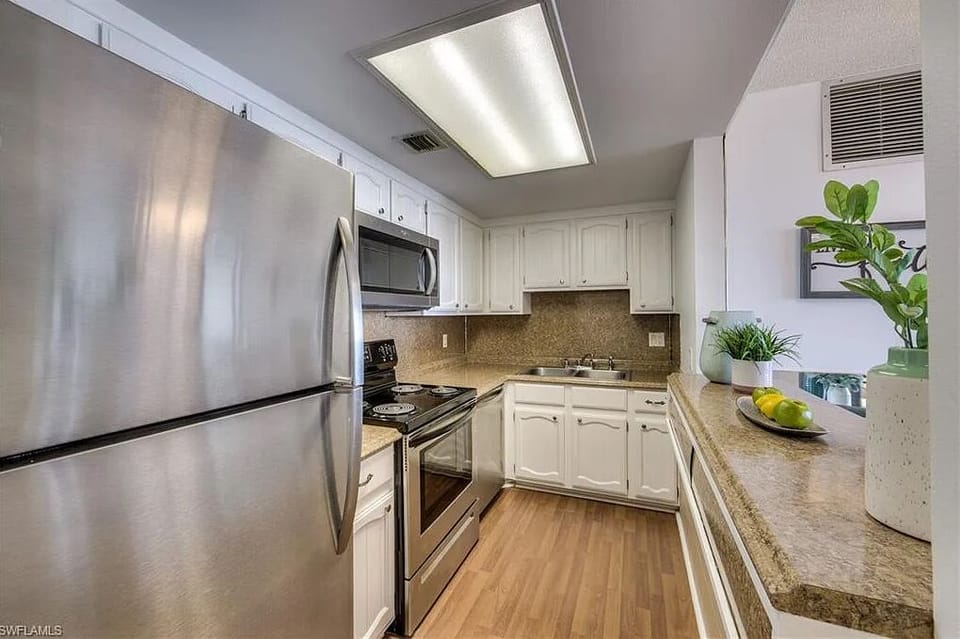 Fully equipped galley kitchen with stainless steel appliances 