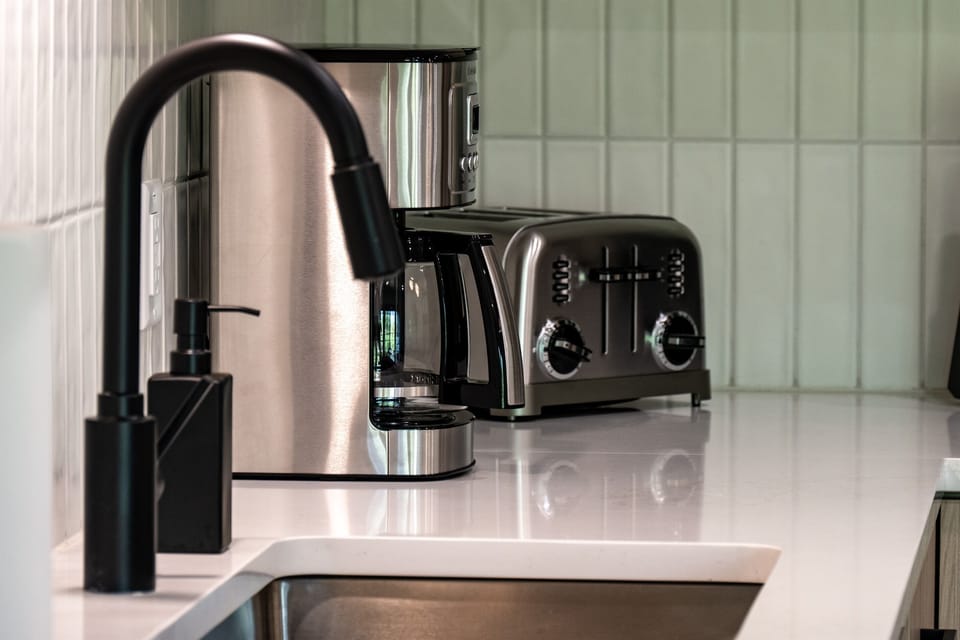 Quartz countertops and new fixtures make clean-up effortless.