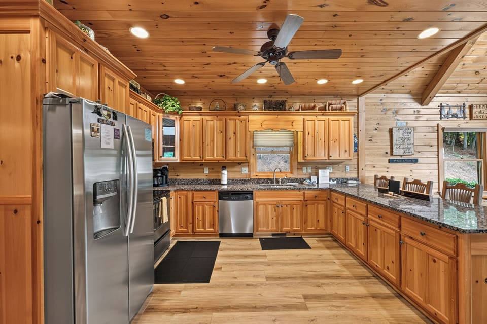 Rustic kitchen with granite countertops and stainless steel appliances, ideal for family cooking.