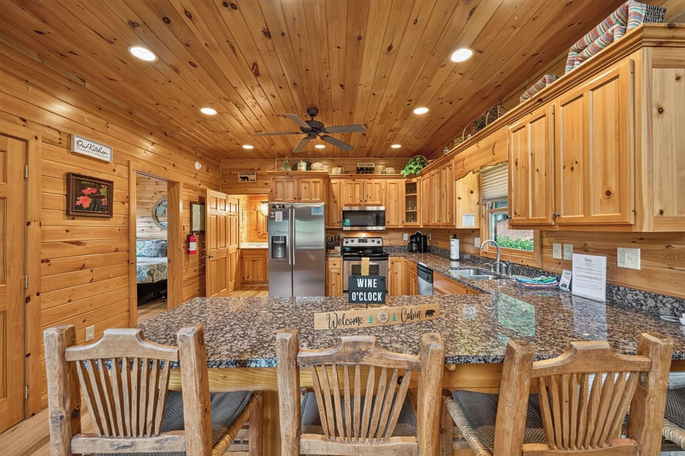 Rustic kitchen with granite countertops and modern appliances, perfect for cozy cabin meals.