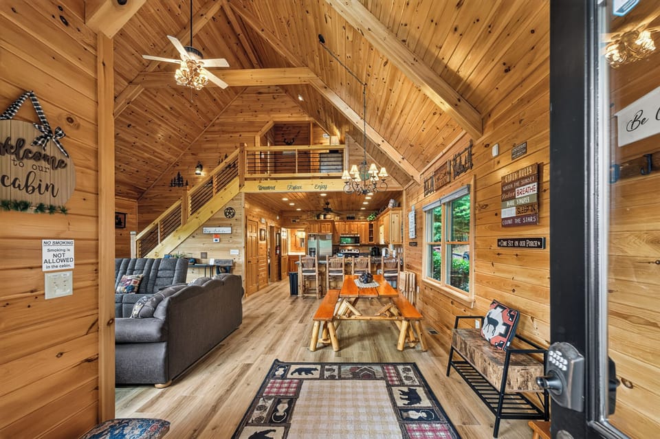Rustic open-plan cabin with cozy seating and a welcoming dining area for family gatherings.