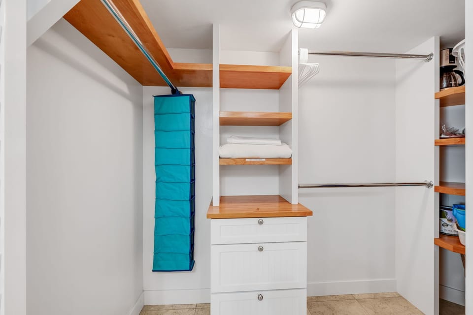 The walk-in closet provides ample space for luggages and clothes