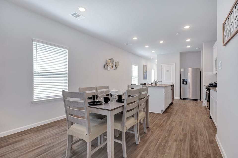 Spacious dining area that comfortably seats six, ideal for family meals.