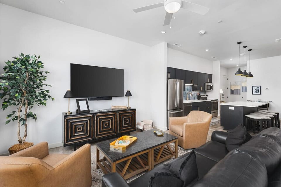 Comfortable living room with a Queen pull-out couch, room darkening shades, a Smart TV, and private patio in this corner unit condo on Music Row.