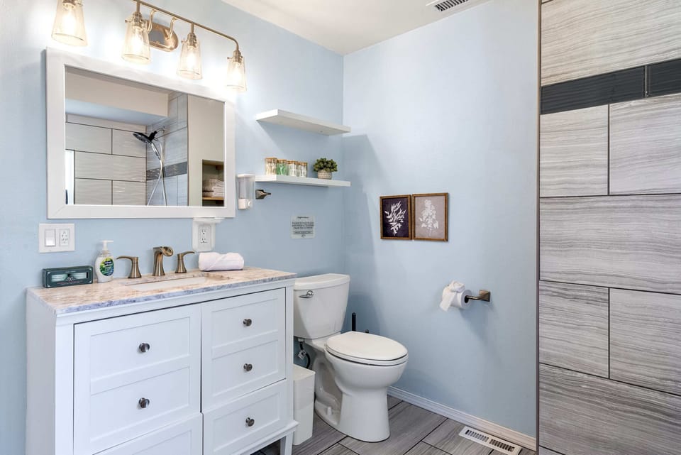 Feel at home in our elegant bathroom, featuring chic decor, a roomy vanity, and premium amenities.