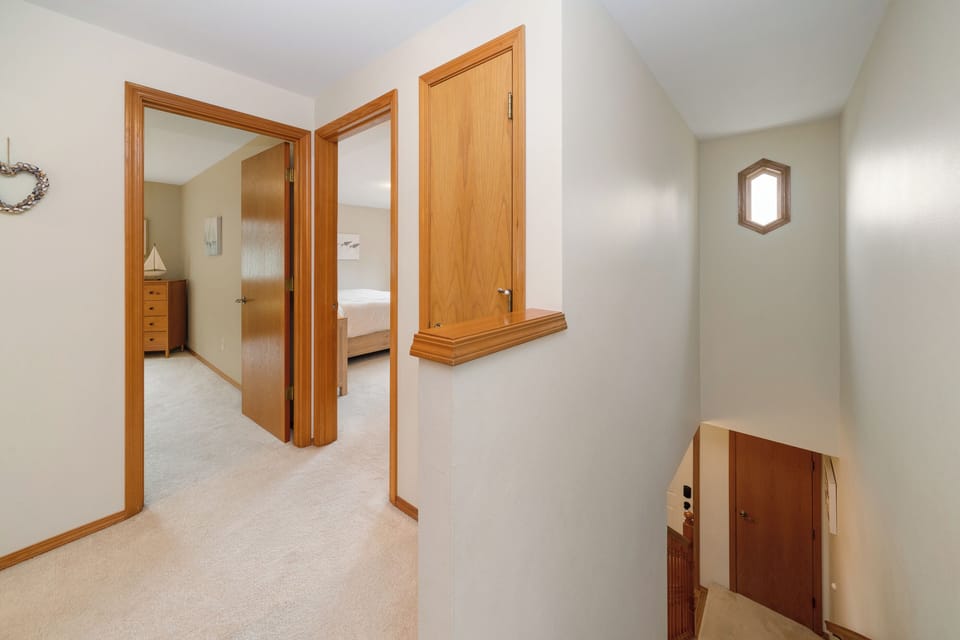 Upstairs hallway with entrance to upstairs bedrooms.