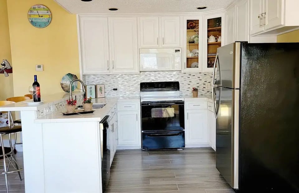 Full size fridge, Stainless steel sink and faucet, oven, granite counter top