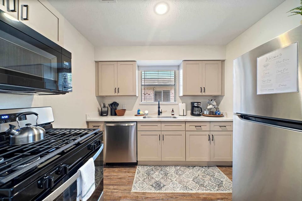 Kitchen: Sleek stainless steel appliances meet stylish decor, perfect for culinary adventures.