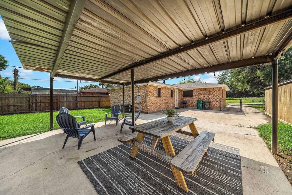 Outdoor Oasis: Enjoy al fresco dining and games in this spacious, shaded backyard retreat!