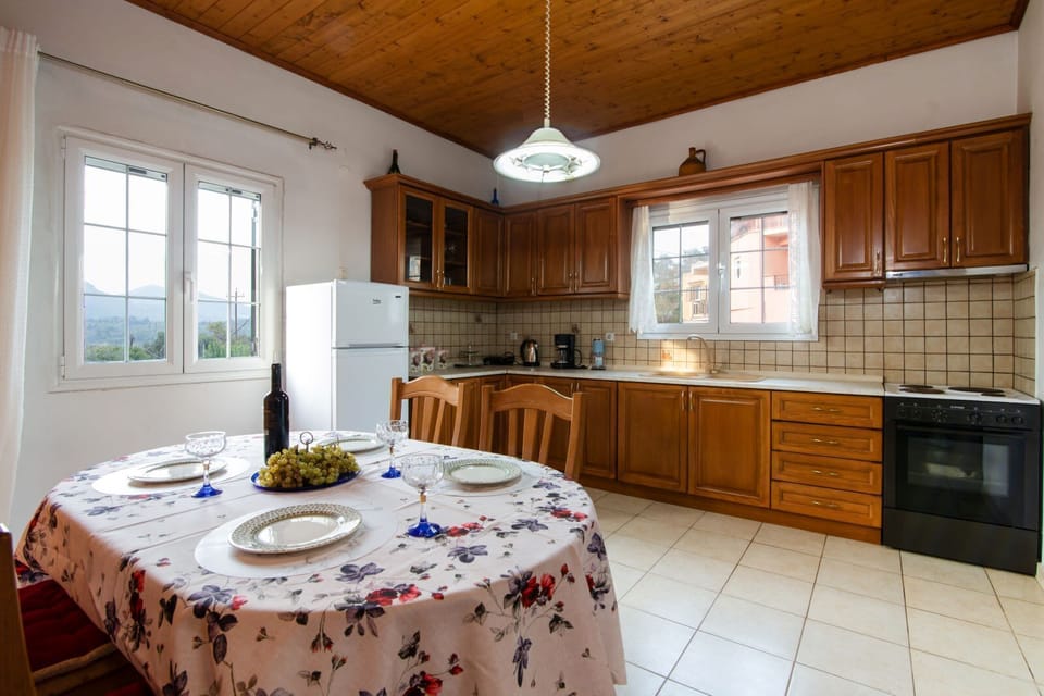 Dining Area with Round Wooden Table and Bright Window Views – Perfect for enjoying meals together.