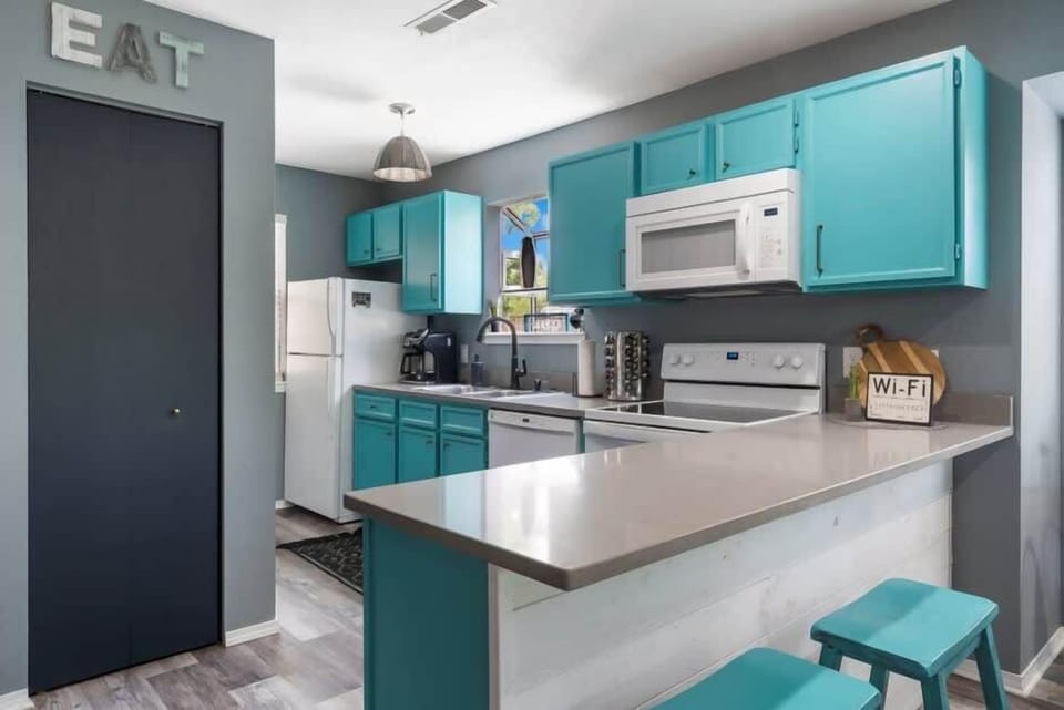 The open Kitchen offers plenty of amenities and additional counter seating for 2