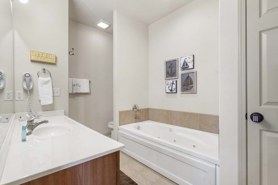 Master en-suite master bathroom with jet tub and stand-in shower