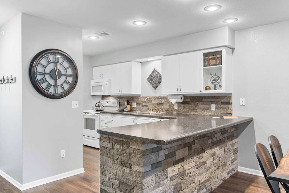 The airy, open kitchen is fully equipped with all the comforts of home