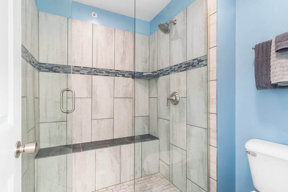 This en suite bathroom offers ample counterspace & a glass shower