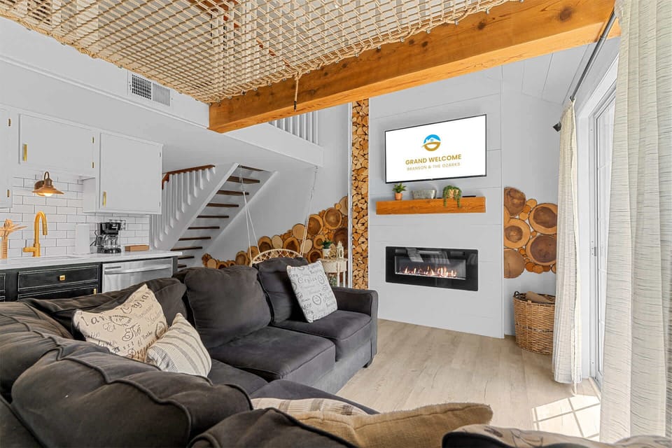 Cozy and spacious living area with TV and fireplace
