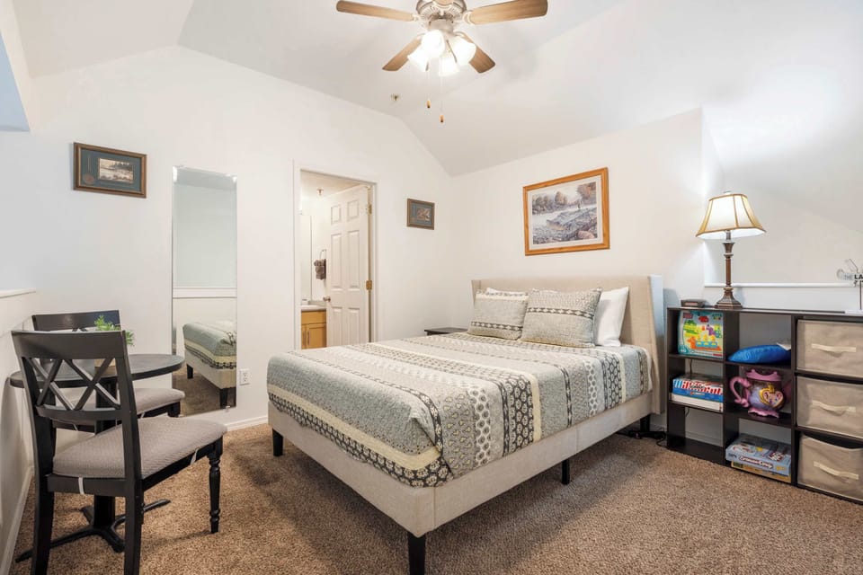 The loft bedroom features a queen bed, sitting area with games, & ensuite