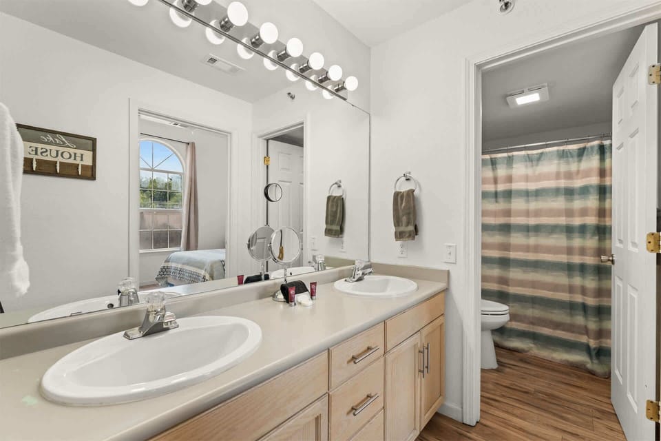 A double vanity & shower/tub combo await in this large ensuite bath