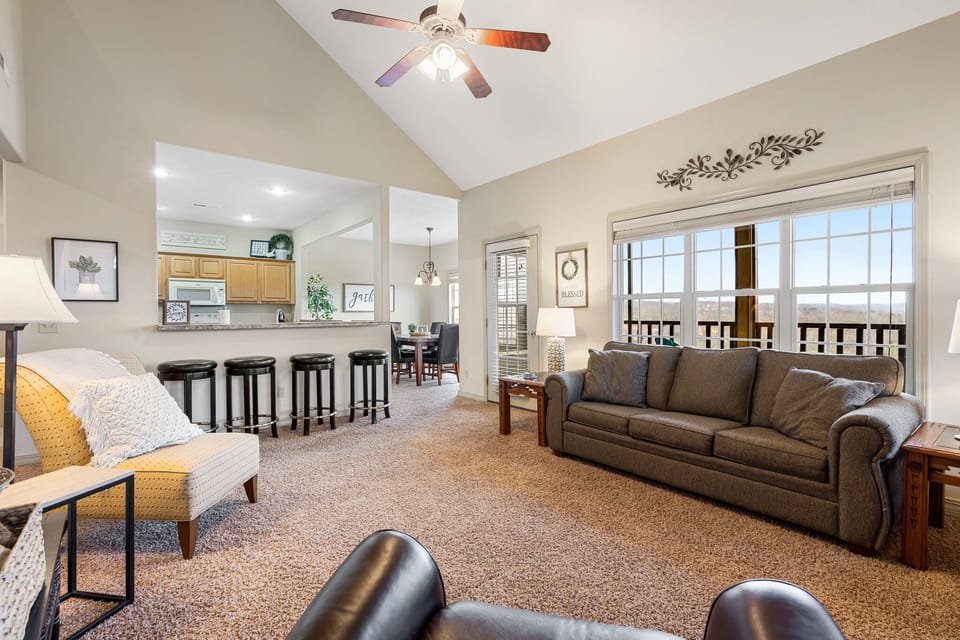 Open living space, counter seating, and dining table