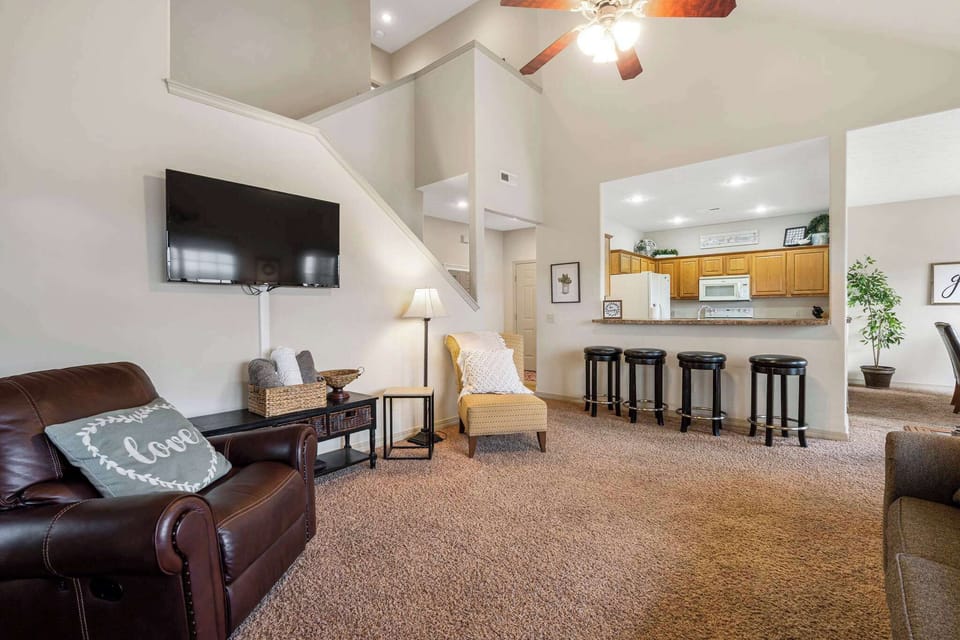 Open living space with, sofa sleeper, Smart TV, fireplace, and screened deck access