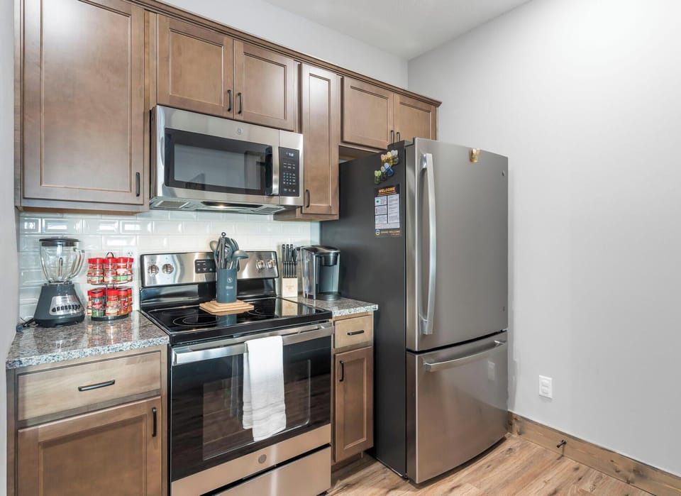 The sophisticated kitchen offers ample space & all the comforts of home