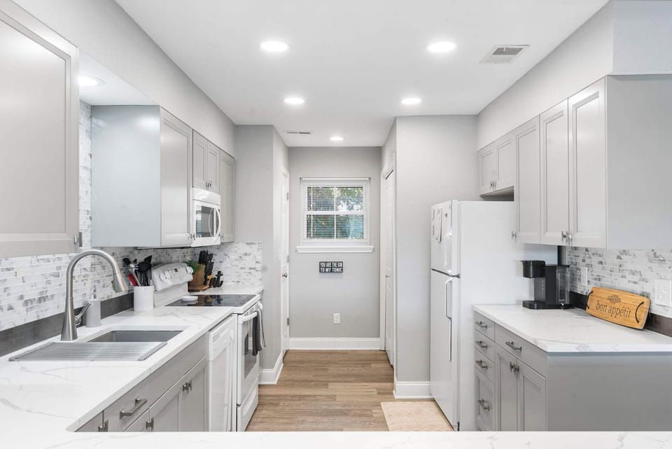 The chic kitchen is spacious & well-equipped with all the comforts of home