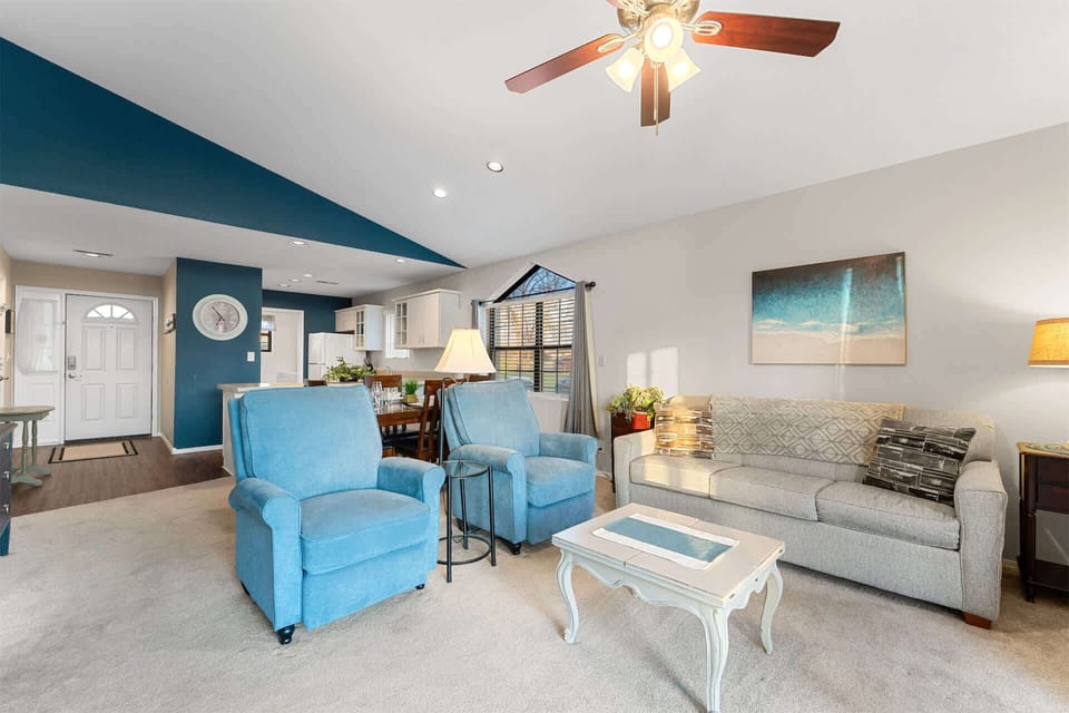 Open living space with Queen sofa sleeper, TV, and balcony access