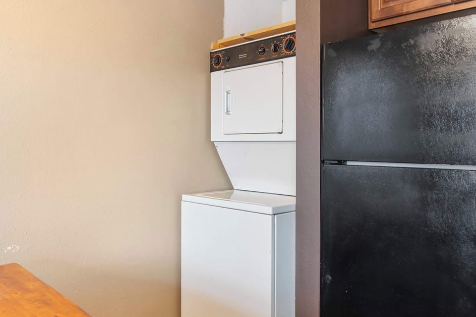 Private laundry is available for your stay, tucked away in the kitchen