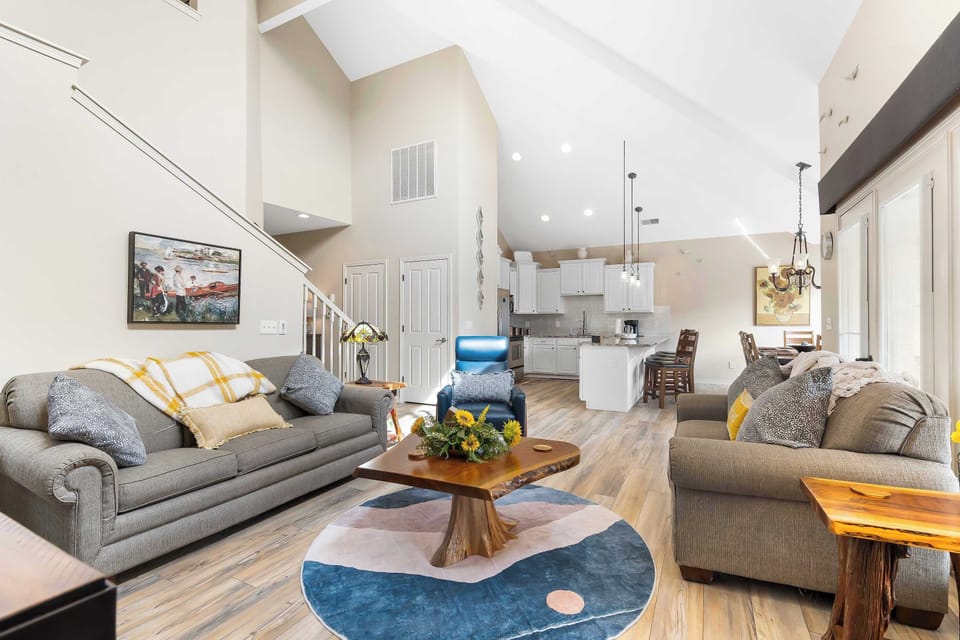 Spacious living room with balcony access TV, and Queen size sofa sleeper