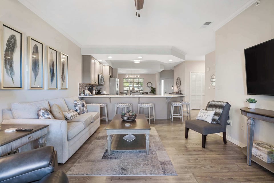 Open living space with Smart TV, sofa sleeper, balcony & sunroom access