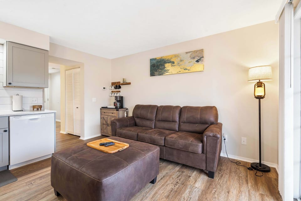Cozy living space with sofa sleeper, fireplace, and Smart TV