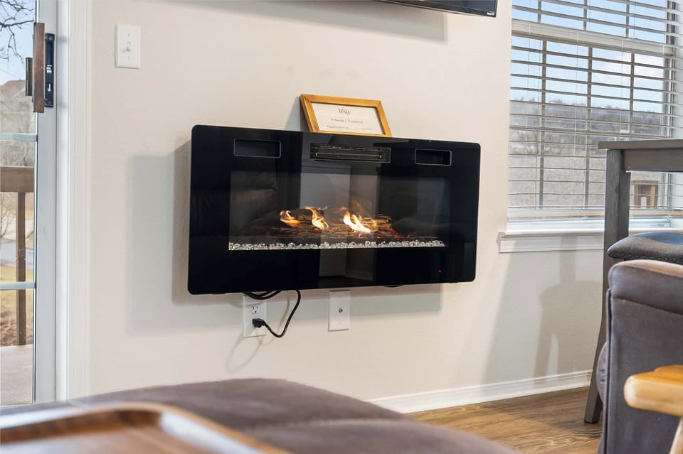 Cozy living space with sofa sleeper, fireplace, and Smart TV