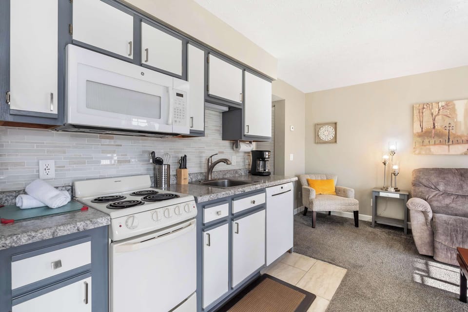 The airy kitchen area offers ample storage space & all the comforts of home