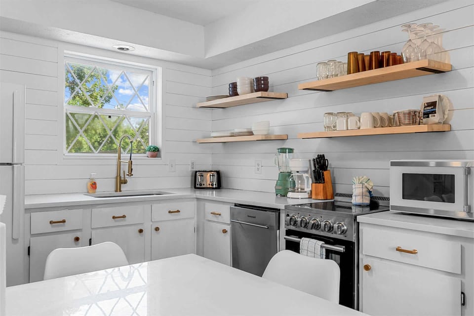 The bright, airy kitchen offers ample space & all the comforts of home