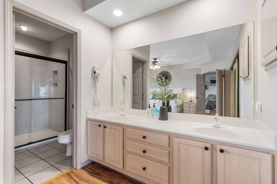 The king suite boasts patio access, a spacious en suite with walk in shower, & TV