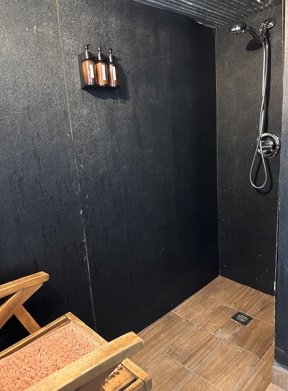Shared bathhouse has shower, sink, and toilet
