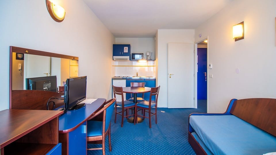 Prepare meals in the kitchenette and enjoy them at the dining table.