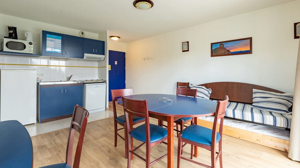 Bright and welcoming space with a fully equipped kitchenette, dining table, and a cozy seating area—perfect for unwinding after a day of exploring.