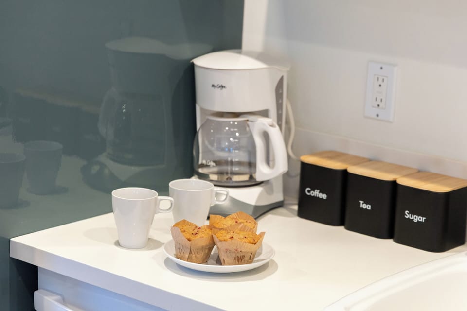 Modern, fully equipped kitchen with gas range, microwave, and stylish open shelving—perfect for easy meals and casual cooking.