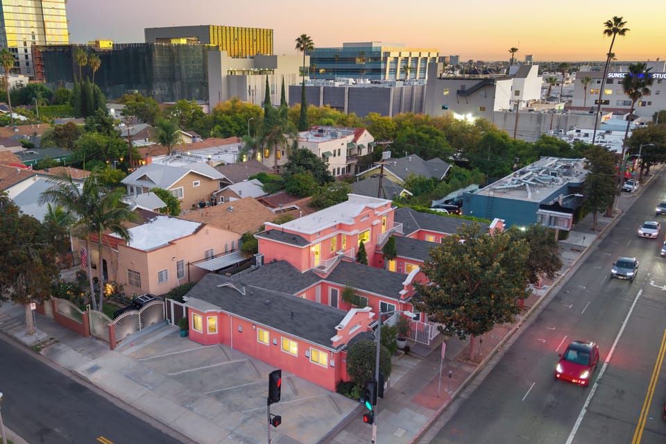 Aerial view of this charming pink retreat, nestled in a palm-lined neighborhood close to the city buzz.