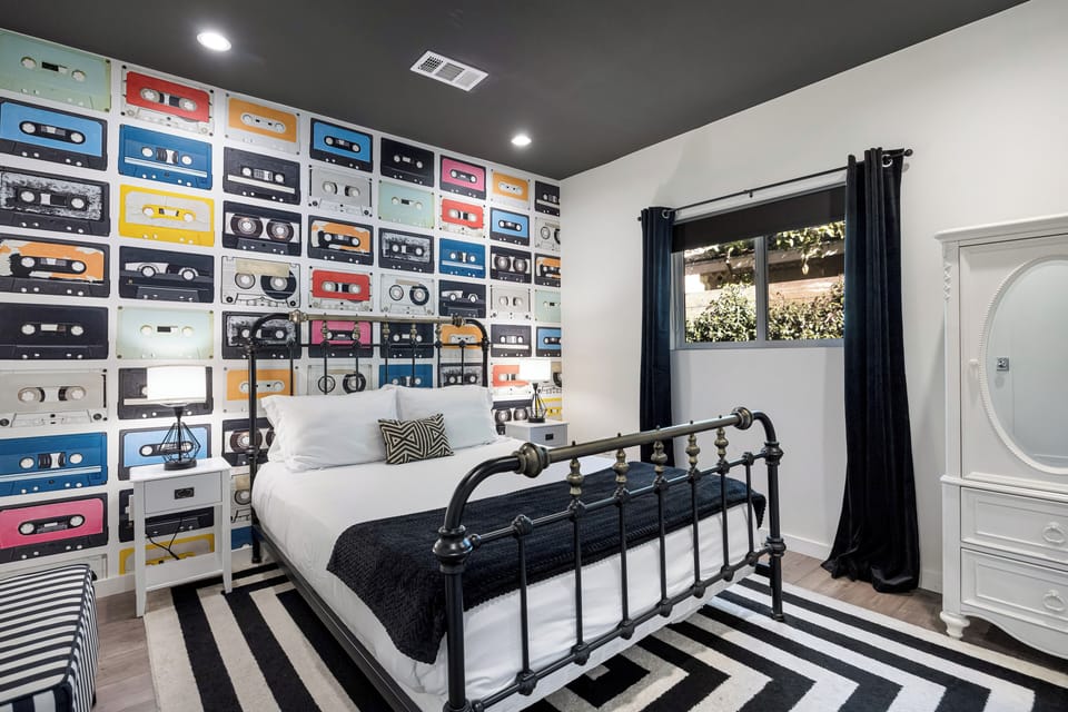 The primary bedroom features a queen bed, TV and an ensuite bathroom.