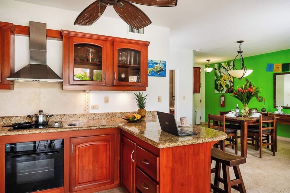 Balcony off the kitchen and dining area, perfect for enjoying tropical breezes, morning coffee, or relaxing meals while overlooking the lush gardens of this Langosta Beach condo during your Tamarindo vacation.