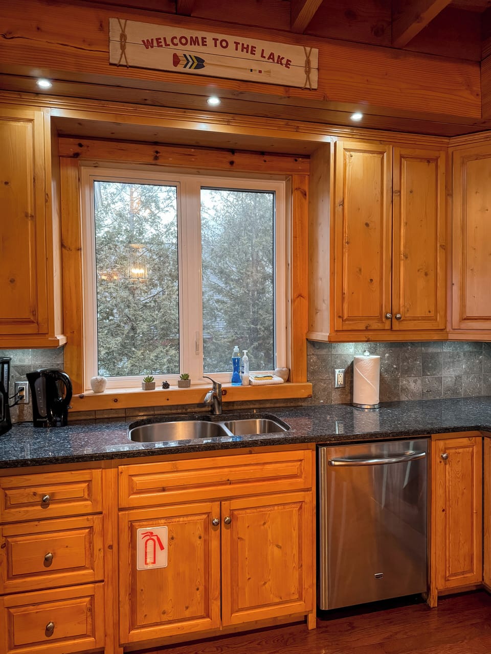 Bright kitchen with lake views and rustic charm—perfect for cooking, relaxing, and enjoying cozy cottage getaways or lakeside vacations.