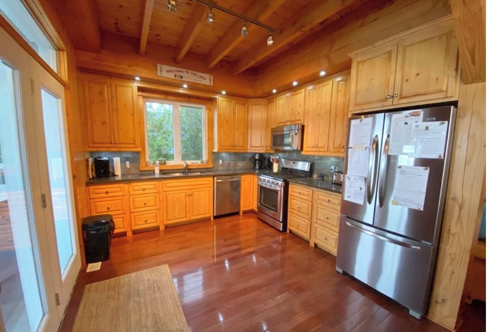 Prepare meals in this modern kitchen with high-end appliances and ample storage. The wood cabinetry adds a rustic charm, making it as beautiful as it is functional.