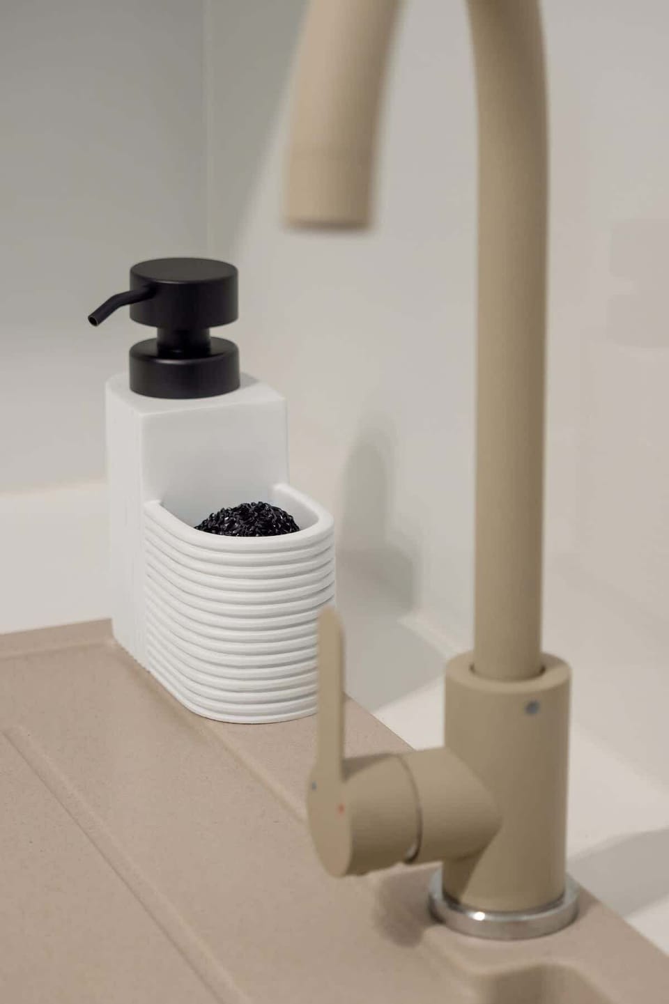 Close-up of modern faucet and kitchen accessories emphasizing the high-quality finish of the interior.