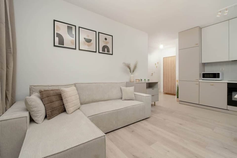 Spacious living room with a dining area and large balcony window provides brightness and functionality.