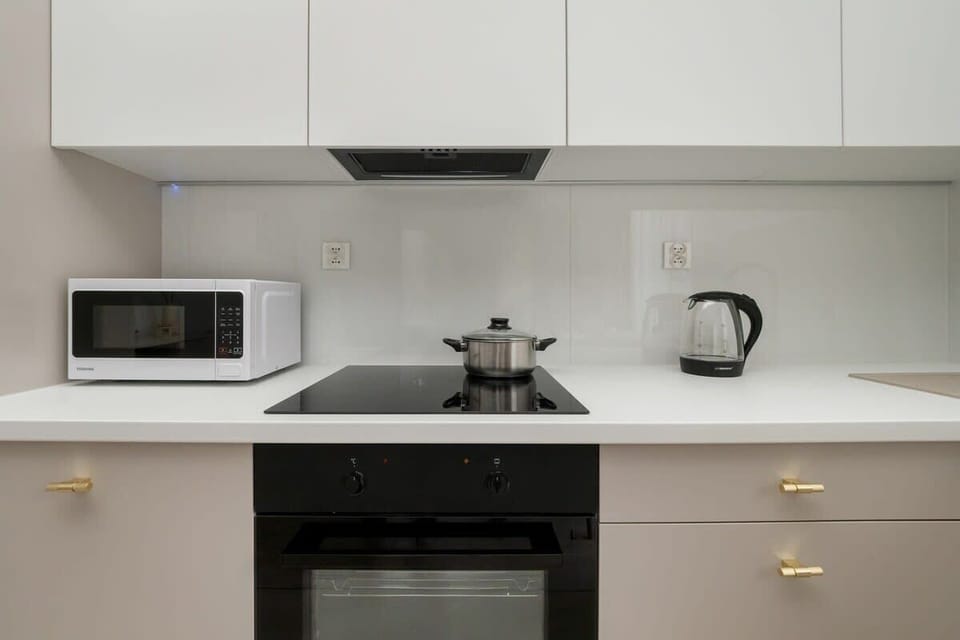 Kitchenette with microwave, oven, and kettle ensures convenience and independence.