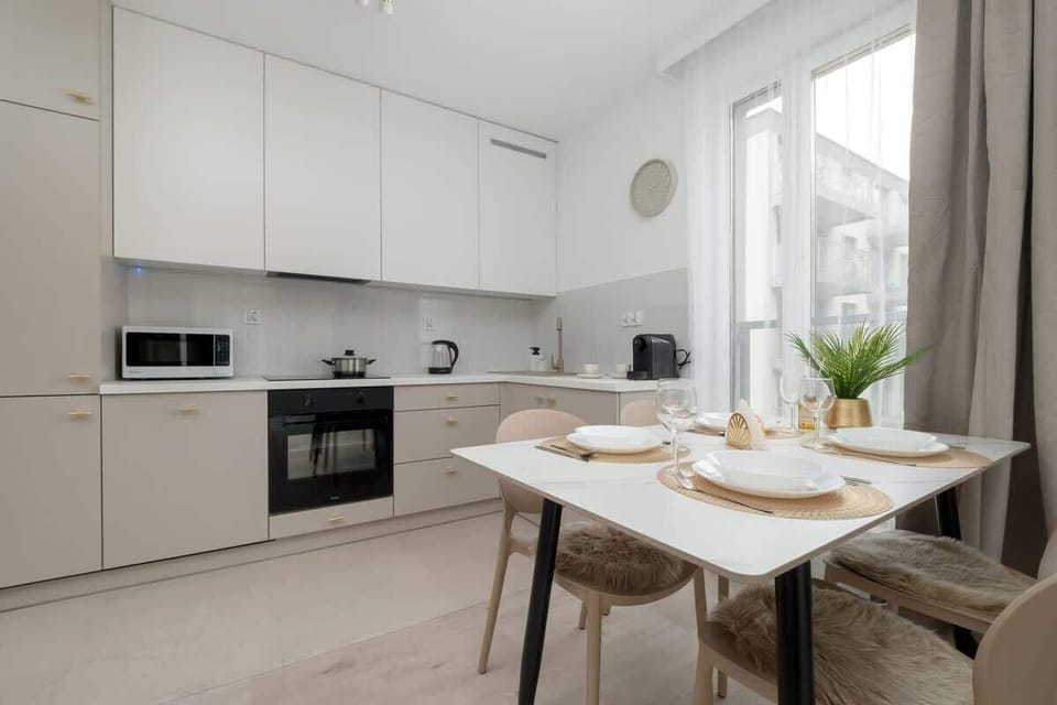 Modern table with elegant setting and plant decoration invites shared meals.